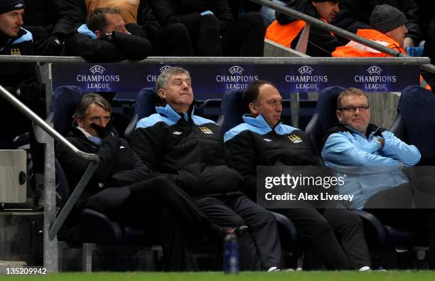 Manchester City Manager Roberto Mancini and Asistants Brian Kidd and David Platt look dejected during the UEFA Champions League Group A match between...