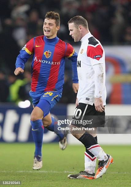 Wayne Rooney of Manchester United shows his disappointment as Granit Xhaka of FC Basel celebrates after the UEFA Champions League Group C match...