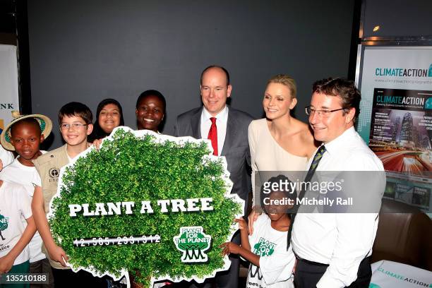 Prince Albert II of Monaco and Princess Charlene of Monaco pose with members of the Stop Talking Start Planting team attend the Climate Action...