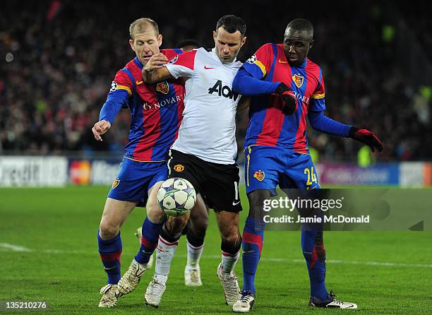 Scott Chipperfield and Cabral of Basel close down Ryan Giggs of Manchester United during the UEFA Champions League Group C match between FC Basel...