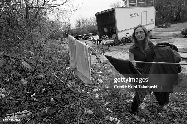 Judy Beck hangs laundry outside abandoned truck trailer where she lives with James Morrison April 16, 2007 in Rockford, Illinois. Morrison, born in...