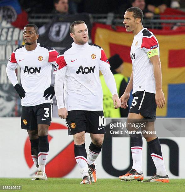 Patrice Evra, Wayne Rooney and Rio Ferdinand of Manchester United show their disappointment during the UEFA Champions League Group C match between FC...