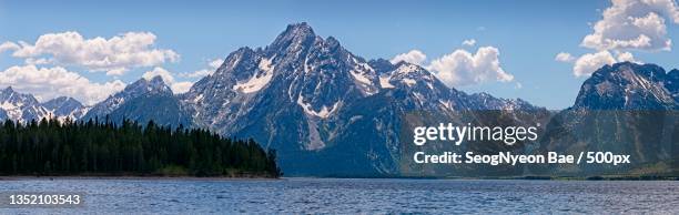 panoramic view of lake and mountains against sky,colter bay village,wyoming,united states,usa - colter bay stock pictures, royalty-free photos & images