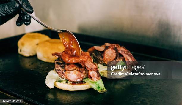 chef arranging burgers. - bbq sandwich stock pictures, royalty-free photos & images