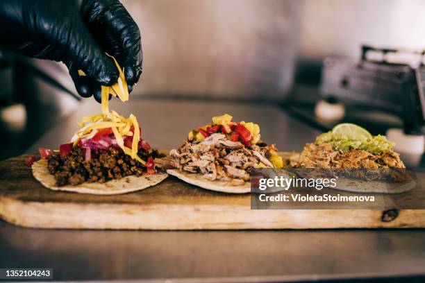 chef preparing tacos - foodtruck stock pictures, royalty-free photos & images