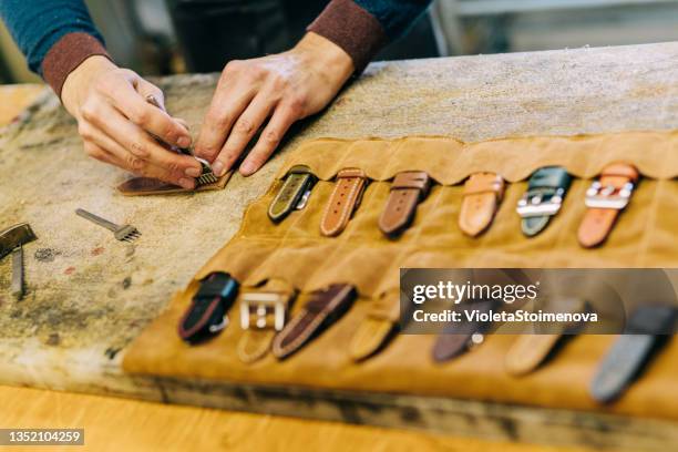 young craftsperson making leather watch strap. - bracelet making stock pictures, royalty-free photos & images