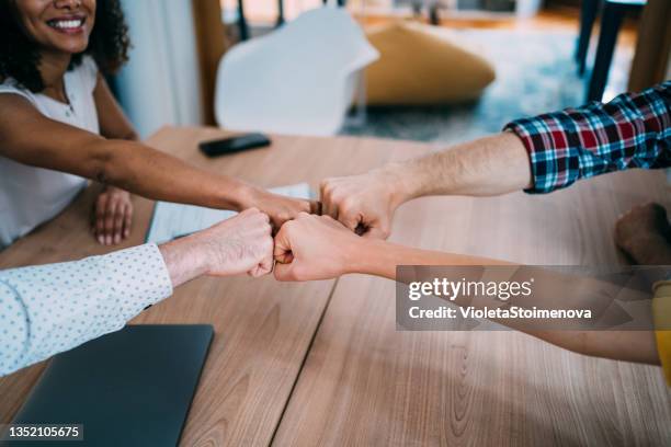 fist bump greeting! - fist bump stock pictures, royalty-free photos & images