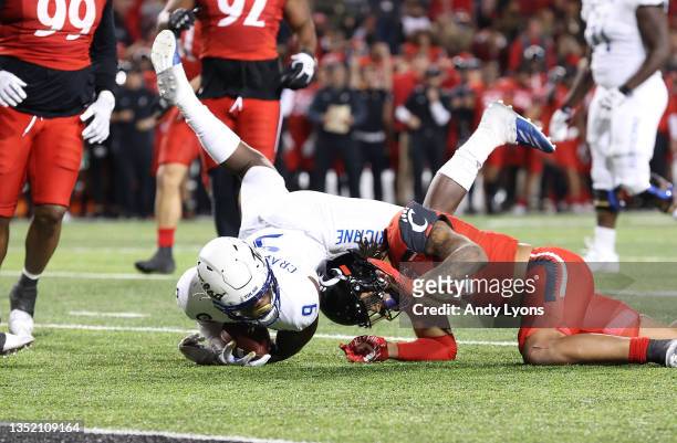 Sam Crawford Jr of the Tulsa Golden Hurricane is stopped short on 4th down yards away from the goal line by Deshawn Pace of the Cincinnati Bearcats...