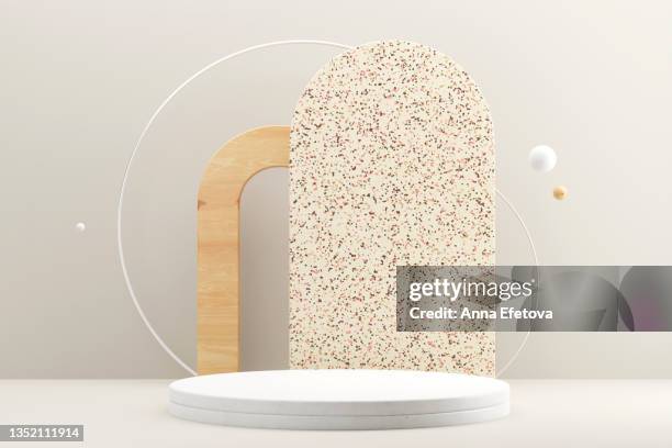 round white ceramic podium with white metal circle frame, wooden frame and abstract shape ceramic backstop with terrazzo pattern. three multi material bubbles are flying around this composition. trendy backdrop for your design - mural objeto manufaturado - fotografias e filmes do acervo