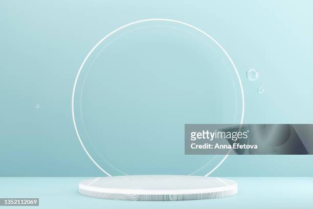 round white wooden podium on light blue background with thin round white border and three glass bubble. perfect platform for showing your products. three dimensional illustration - sports round stock-fotos und bilder