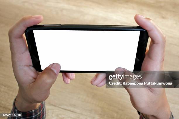 man playing games on a smartphone - telephone game stock pictures, royalty-free photos & images