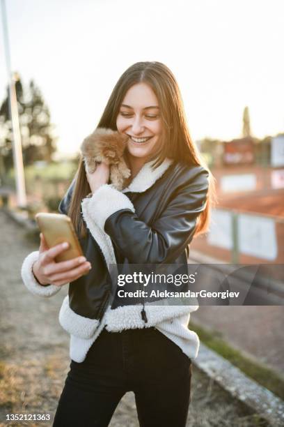 selfie time for female teenager and her new kitten outside - cat selfie stock pictures, royalty-free photos & images