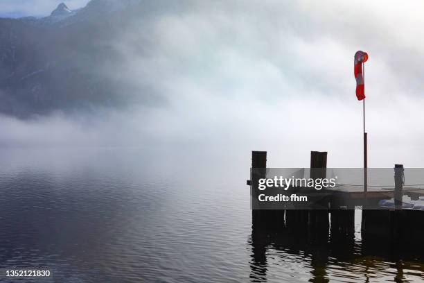 lake hallstatt with morning fog and windsack - windsack stock pictures, royalty-free photos & images