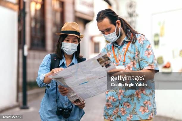 japanese young woman asking for direction to tour guide - madrid places to visit stock pictures, royalty-free photos & images