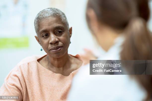 cancer patient talking with a doctor - image of patient stock pictures, royalty-free photos & images