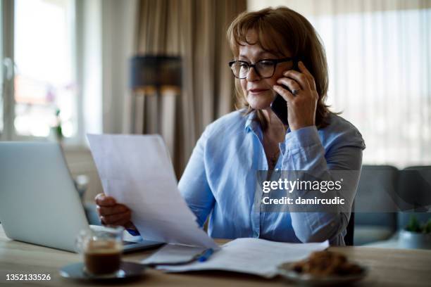 senior woman working at home - klaga bildbanksfoton och bilder