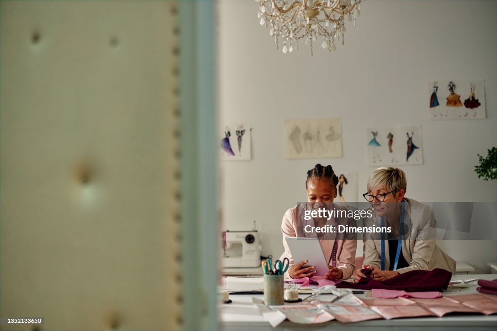 Two fashion designers collaborating at workshop
