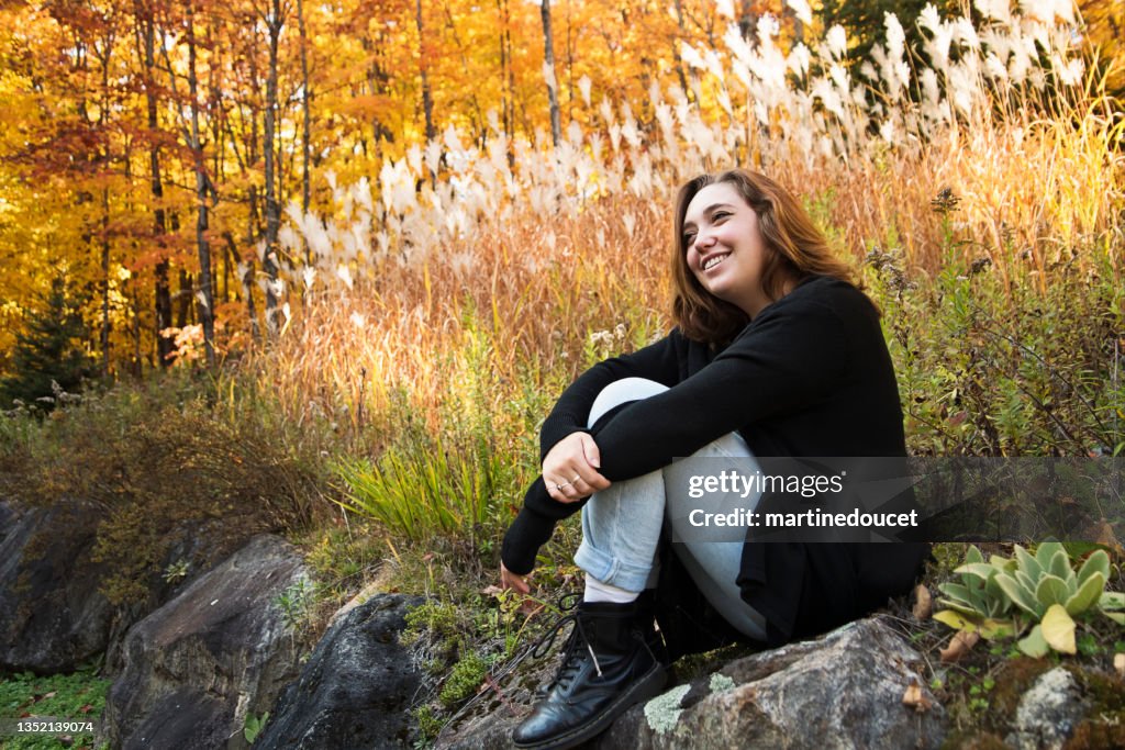 Portrait of happy young woman in autumn nature.