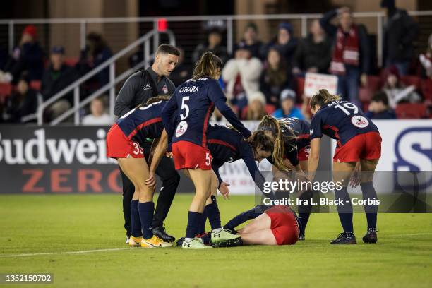 Tori Huster of Washington Spirit lies on the pitch with teammates surrounding her in overtime of the NWSL Quarterfinals match against North Carolina...