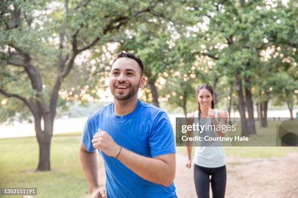 young attractive couple running - speed walking stock pictures, royalty-free photos & images
