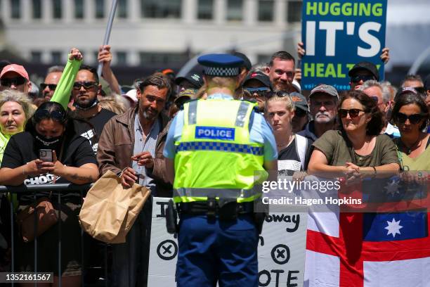 Police officer faces protestors during a Freedom and Rights Coalition protest at Parliament on November 09, 2021 in Wellington, New Zealand....