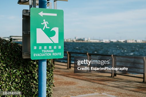 Close up of tsunami evacuation route sign Close up of tsunami evacuation route sign