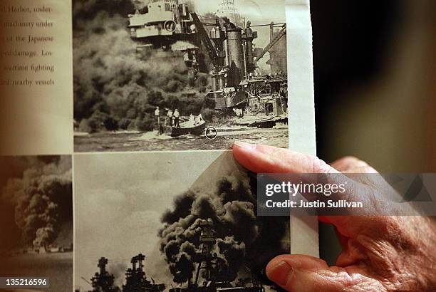 Navy veteran and Pearl Harbor survivor John Chaoman points to a picture of himself in the water after the USS West Virginia was hit during a Pearl...