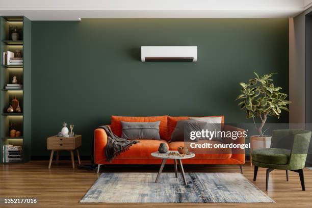 modern living room interior with air conditioner, orange sofa and green armchair - wall summer light imagens e fotografias de stock