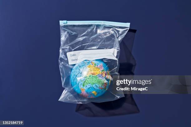 earth globe packed in plastic bag - mason jar stock pictures, royalty-free photos & images
