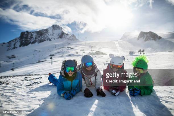 mother and three kids enjoying skiing at glacier in the alps - family ice nature stock pictures, royalty-free photos & images