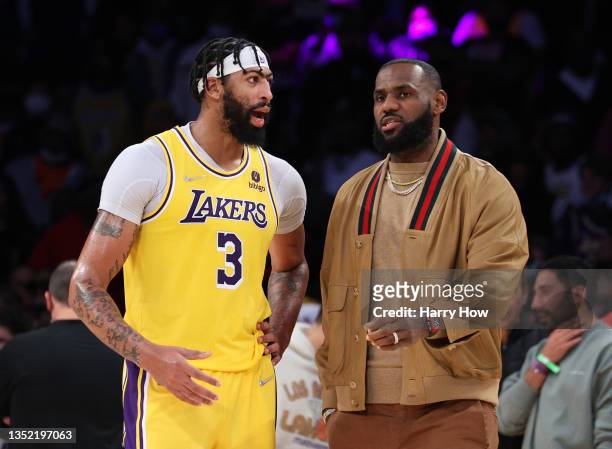 Anthony Davis and LeBron James of the Los Angeles Lakers talk after a timeout during a 126-123 Lakers overtime win over the Charlotte Hornets at...