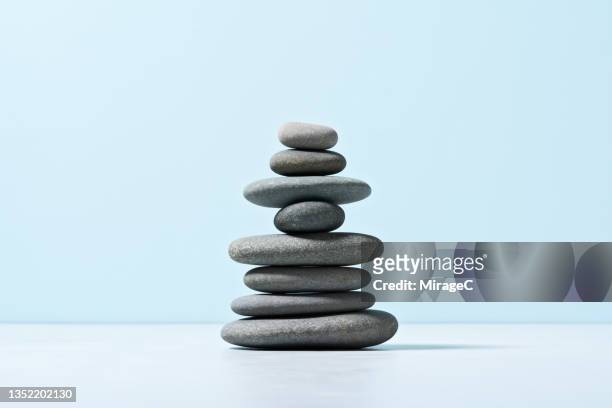 stack of balanced natural gray pebbles - feng shui stock pictures, royalty-free photos & images