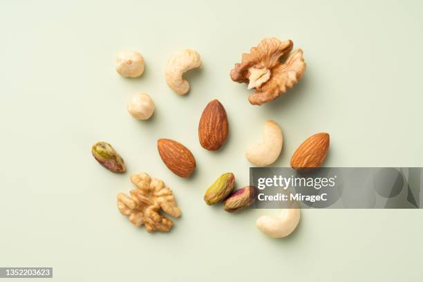 mixed nuts assortment arrangement - fruto seco fotografías e imágenes de stock