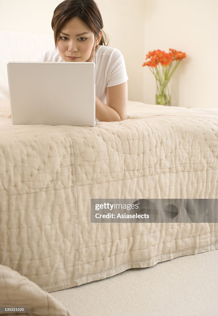 Close-up of a young woman using a laptop