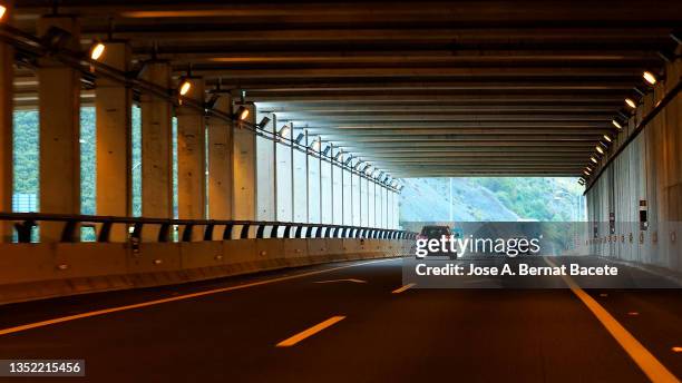 car point of view driving, cars driving on a highway exiting a tunnel - cars on a road sunny photos et images de collection