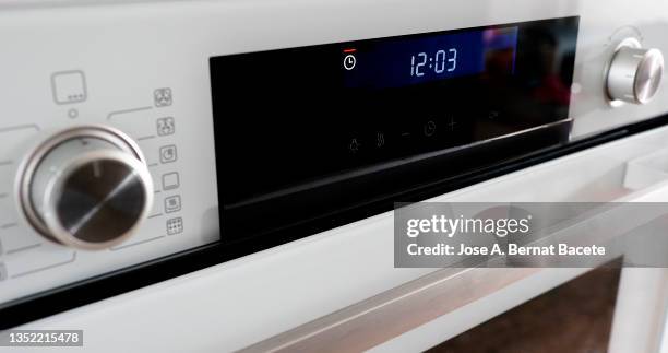 buttons and control panel of a modern oven with the clock timer flashing. - cooker dial stock pictures, royalty-free photos & images