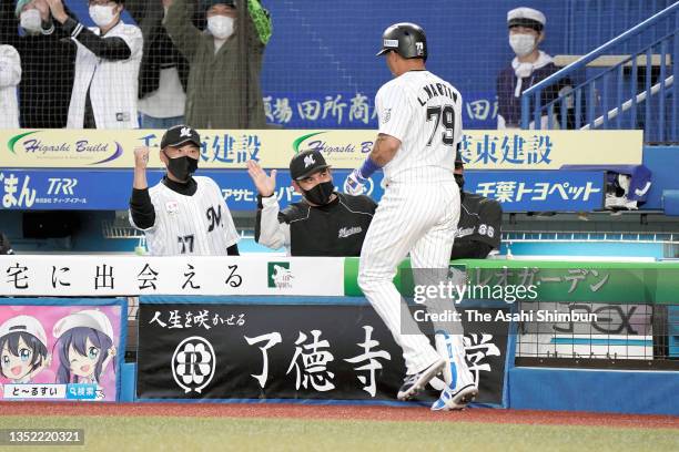 Leonys Martin of the Chiba Lotte Marines celebrates with head coach Tadahito Iguchi after hitting a solo home run in the 7th inning against Tohoku...