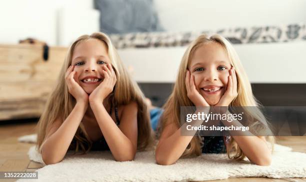shot of two sisters spending time together - twin girls bildbanksfoton och bilder