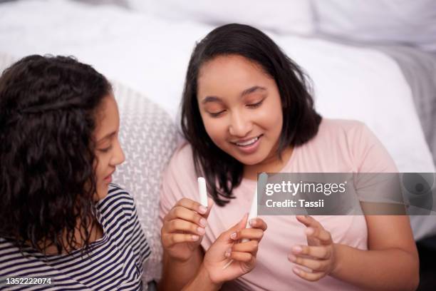 cropped shot of two teenage girls talking about menstruation at home - menstruation stock pictures, royalty-free photos & images