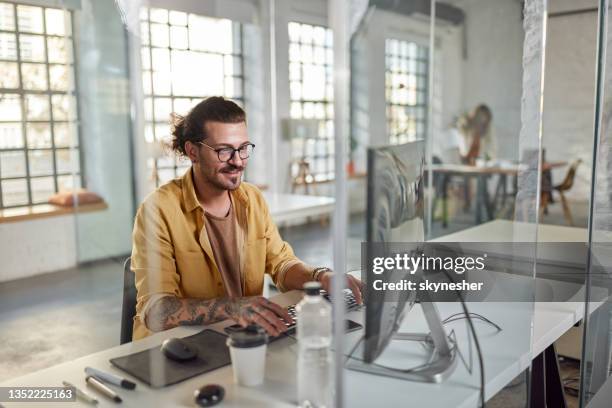 happy programmer working on desktop pc in the office. - happy programmer stock pictures, royalty-free photos & images