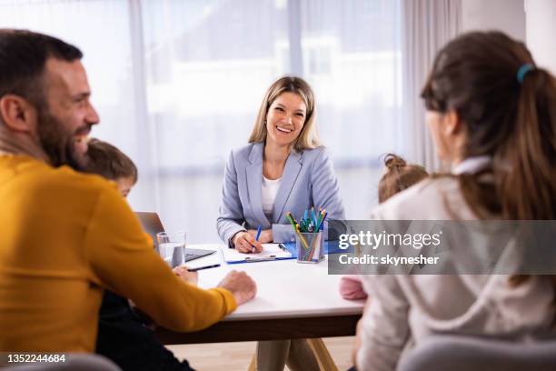 happy therapist talking to a family on counseling session in the office. - principal stock pictures, royalty-free photos & images