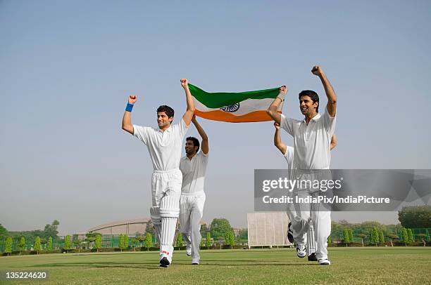 players holding the national flag - india national cricket stock pictures, royalty-free photos & images