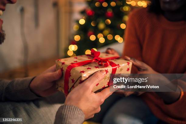 woman receiving a present from her boyfriend - exchanging gifts stock pictures, royalty-free photos & images