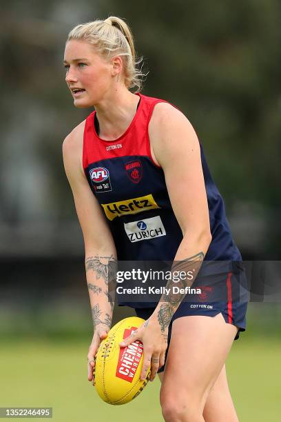 Tayla Harris of the Demons runs with the ball during a Melbourne Demons AFLW training session at Gosch's Paddock on November 09, 2021 in Melbourne,...