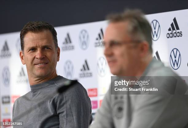 Oliver Bierhoff, Manager of the German national football team looks over to Professor Doctor Tim Meyer, team doctor during a press conference on...