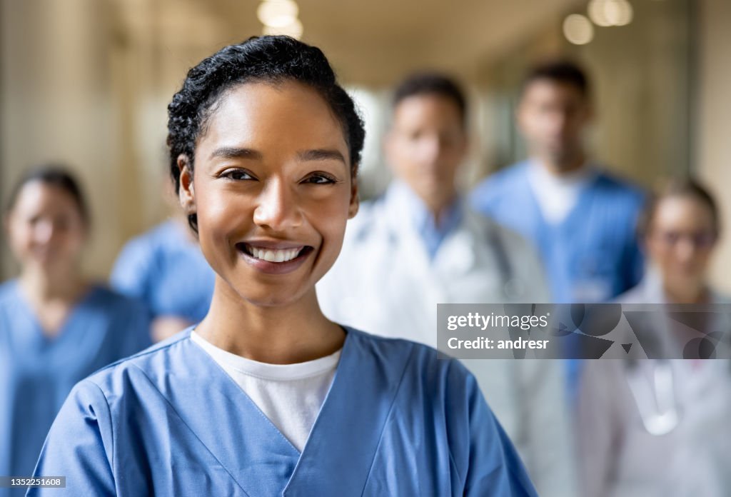 Happy chief nurse working at the hospital with a group of healthcare workers