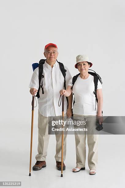 portrait of a couple holding a hiking pole - hiking pole stock-fotos und bilder