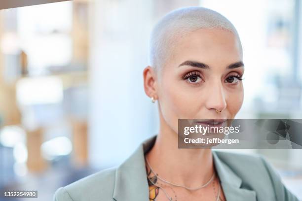 shot of a beautiful young businesswoman in her office - shaved head stockfoto's en -beelden