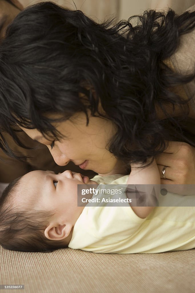 Close-up of a mid adult woman playing with her daughter