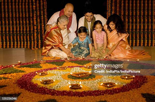 family sitting near rangoli - diwali family stock pictures, royalty-free photos & images